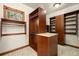 Spacious walk-in closet with custom wood shelving, drawers, a window, and carpeted flooring at 7115 Parkwood Ln, Castle Pines, CO 80108