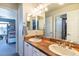 Well-lit bathroom features a double sink vanity with neutral countertops at 2879 Hilltop Ct, Broomfield, CO 80023