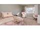 Bedroom with a hanging chair, lots of natural light, carpet, and a comfortable chair at 2879 Hilltop Ct, Broomfield, CO 80023