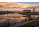 Scenic view of a sunset reflected on a pond and a gazebo on a small island at 2879 Hilltop Ct, Broomfield, CO 80023