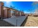 Backyard features brick home, concrete patio, and beautiful mountain views at 2813 S Ivan Way, Denver, CO 80227