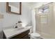 A bathroom with a shower stall, a white marble countertop on a wood vanity, and a framed mirror at 2813 S Ivan Way, Denver, CO 80227