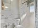 Bathroom featuring a white sink, toilet and tiled shower at 2813 S Ivan Way, Denver, CO 80227