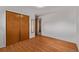 Bedroom showcasing wood floors, large closet, and neutral walls at 2813 S Ivan Way, Denver, CO 80227