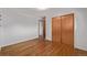 Bedroom with hardwood floors and a closet with wood doors at 2813 S Ivan Way, Denver, CO 80227