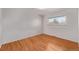 Bright bedroom features gleaming hardwood floors and a window with outside views at 2813 S Ivan Way, Denver, CO 80227