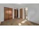 Bedroom featuring neutral carpet, closet, and attached bath at 2813 S Ivan Way, Denver, CO 80227