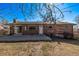 Brick home with large windows and sliding glass doors, leading to a patio at 2813 S Ivan Way, Denver, CO 80227