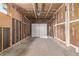 Unfinished garage with concrete floor and white door, ready for your vehicles at 2813 S Ivan Way, Denver, CO 80227