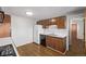Functional kitchen featuring wooden cabinets, a white refrigerator, black dishwasher, and hardwood floors at 2813 S Ivan Way, Denver, CO 80227