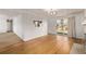 View of living room leading to the backyard through sliding glass doors and with hardwood floors at 2813 S Ivan Way, Denver, CO 80227