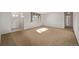 Spacious living room with carpet, a window with curtains, and a white front door at 2813 S Ivan Way, Denver, CO 80227