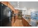 Modern kitchen featuring wood cabinets, granite counters and stainless steel appliances at 5534 Lewis St # 202, Arvada, CO 80002