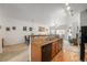 Open kitchen view showcasing breakfast bar with granite countertops and wood cabinets and modern appliances at 5534 Lewis St # 202, Arvada, CO 80002