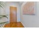 Light and airy entryway with hardwood floors and modern wall art at 2958 Syracuse St # 303, Denver, CO 80238