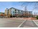 Modern building exterior with ample parking at 2958 Syracuse St # 303, Denver, CO 80238