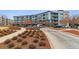 Modern building with landscaping and parking at 2958 Syracuse St # 303, Denver, CO 80238