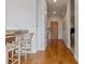 Hardwood floor hallway with access to kitchen and bedrooms at 2958 Syracuse St # 303, Denver, CO 80238