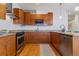 Modern kitchen with wood cabinets and granite countertops at 2958 Syracuse St # 303, Denver, CO 80238