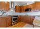 Modern kitchen with wood cabinets and granite countertops at 2958 Syracuse St # 303, Denver, CO 80238