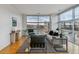 Modern living room with hardwood floors and large windows at 2958 Syracuse St # 303, Denver, CO 80238