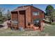 A spacious backyard featuring a wooden deck with patio furniture and a grill at 4484 Juniper Ct, Larkspur, CO 80118