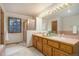 Bathroom with double sink vanity, tiled countertop, and a shower with glass door at 70 Long Bow Cir, Monument, CO 80132