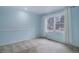 Cozy bedroom featuring soft blue walls, plush carpeting, and a bright window at 70 Long Bow Cir, Monument, CO 80132