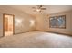 Spacious main bedroom with carpet, a ceiling fan, and a view of the outside landscape at 70 Long Bow Cir, Monument, CO 80132