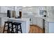 Updated kitchen featuring white cabinets, quartz countertops, stainless appliances, and bar seating at 70 Long Bow Cir, Monument, CO 80132