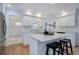 Updated kitchen featuring white cabinets, quartz countertops, stainless appliances, and breakfast bar seating at 70 Long Bow Cir, Monument, CO 80132