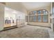 Open-concept living room with large windows, adjoined to a modern kitchen and breakfast bar at 70 Long Bow Cir, Monument, CO 80132