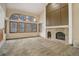 Bright living room featuring high ceilings, arched windows, and a classic brick fireplace at 70 Long Bow Cir, Monument, CO 80132