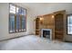 Bright living room with large windows, built-in shelving, and a cozy fireplace at 70 Long Bow Cir, Monument, CO 80132