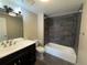 Updated bathroom featuring a shower and tub combination, updated light fixture, vanity, and tiling at 7865 E Mississippi Ave # 706, Denver, CO 80247