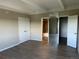 Spacious bedroom with wood flooring, closet, and mirror with view of the bathroom at 7865 E Mississippi Ave # 706, Denver, CO 80247