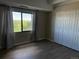 Bedroom with wood flooring, closet, and windows offering outdoor views at 7865 E Mississippi Ave # 706, Denver, CO 80247