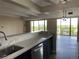 Bright kitchen featuring a breakfast bar, stainless steel appliances, and easy access to the balcony at 7865 E Mississippi Ave # 706, Denver, CO 80247