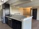 Modern kitchen featuring stainless steel appliances, a breakfast bar, and dark cabinetry at 7865 E Mississippi Ave # 706, Denver, CO 80247