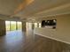 Sunlit living room with hardwood floors and access to balcony, seamlessly connects to the kitchen at 7865 E Mississippi Ave # 706, Denver, CO 80247