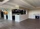 Spacious living area featuring stylish lighting, stone fireplace, and open kitchen area at 7865 E Mississippi Ave # 706, Denver, CO 80247