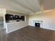 Open living area with fireplace featuring hardwood floors and seamless transition to modern kitchen at 7865 E Mississippi Ave # 706, Denver, CO 80247