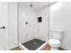 Updated bathroom with a tiled shower, black pebble floor, and sleek fixtures at 220 S Raleigh St, Denver, CO 80219
