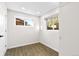 Neutral bedroom with wood-look flooring, white walls, and two windows at 220 S Raleigh St, Denver, CO 80219