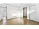 Bedroom featuring laminate flooring, closet, and entry to additional room with natural light at 220 S Raleigh St, Denver, CO 80219