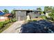 Modern two-story home with a sleek gray exterior, updated landscaping, and a private front yard at 220 S Raleigh St, Denver, CO 80219