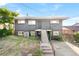 A modern home boasting a contemporary gray facade, landscaped front yard and porch entry at 220 S Raleigh St, Denver, CO 80219