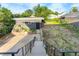 Rear view of the garage with steps leading to the entrance and a lawn at 220 S Raleigh St, Denver, CO 80219
