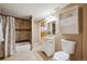 Cozy bathroom featuring a shower and tub combination, tiled floor, and traditional vanity at 6595 Meade Ct, Arvada, CO 80003