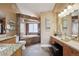 Luxurious bathroom with a soaking tub, dual vanities, and elegant finishes at 6595 Meade Ct, Arvada, CO 80003